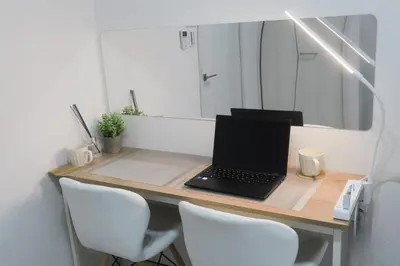 a desk with a laptop computer on it with a mirror at UMI Tokyo Skytree in Tokyo