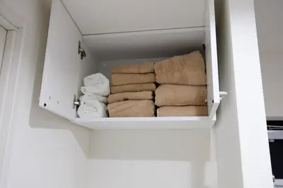 a bunch of folded towels in a cabinet at UMI Tokyo Skytree in Tokyo