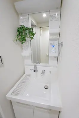 a white bathroom with a sink and a mirror at UMI Tokyo Skytree in Tokyo