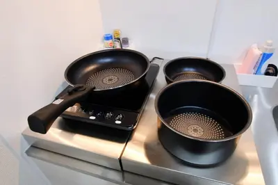 two pots on top of a stove top with autch oven at UMI Tokyo Skytree in Tokyo