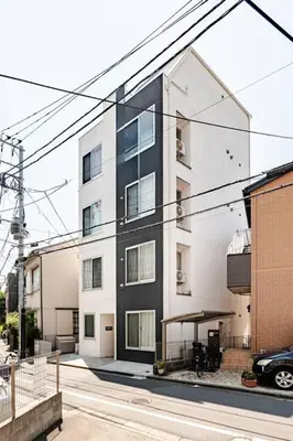 a black and white building on a city street at UMI Tokyo Skytree in Tokyo