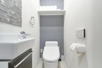 a white bathroom with a toilet and a sink at J-ARC Shinjuku by Tranova in Tokyo