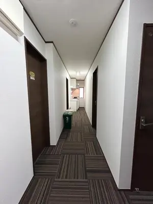 a hallway of a hotel room with a hallway at Sun flower Guest house in Tokyo
