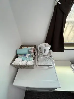 a white table with a tray of items on it at Sun flower Guest house in Tokyo