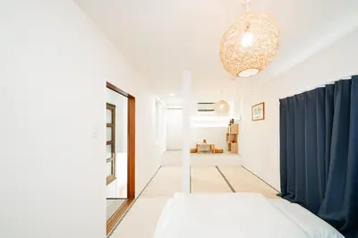 a bedroom with a bed and a blue curtain at 3BR,2BA,2WC with kitchen and living,7min to skytree subway,Max12P in Tokyo