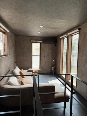 a bedroom with a bed and a balcony with windows at EKVOLI ROPPONGI TOKYO, Private Hotel in Tokyo