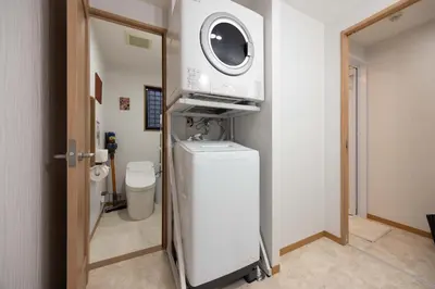 a bathroom with a toilet and a microwave at Clover House in Tokyo