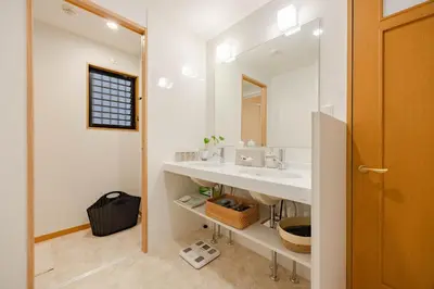 a bathroom with two sinks and a mirror at Clover House in Tokyo
