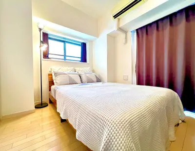 a bedroom with a white bed with a window at Shinjuku-Okubo Cozy Double, Free Wi-Fi in Tokyo
