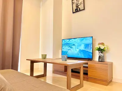 a computer sitting on a wooden table in a room at Shinjuku-Okubo Cozy Double, Free Wi-Fi in Tokyo