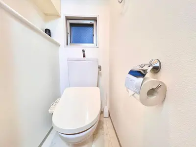 a white toilet in a bathroom with a window at Shinjuku-Okubo Cozy Double, Free Wi-Fi in Tokyo
