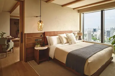 a bedroom with a large bed and a large window at 1 Hotel Tokyo in Tokyo