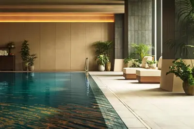a swimming pool in a hotel lobby with plants at 1 Hotel Tokyo in Tokyo