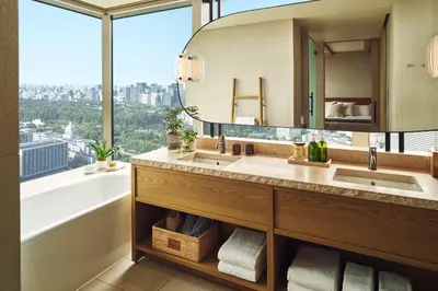 a bathroom with two sinks and a large window at 1 Hotel Tokyo in Tokyo