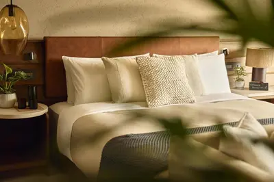 a bedroom with a large bed with white sheets and pillows at 1 Hotel Tokyo in Tokyo