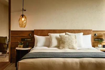 a bedroom with a large bed with white pillows at 1 Hotel Tokyo in Tokyo