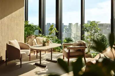 a room with chairs and a table and windows at 1 Hotel Tokyo in Tokyo