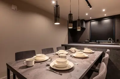 a dining room table with plates and cups on it at Tokyo Waseda Base in Tokyo
