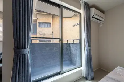 a room with a window with curtains at Tokyo Waseda Base in Tokyo