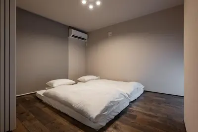 a bedroom with a white bed with two pillows at Tokyo Waseda Base in Tokyo