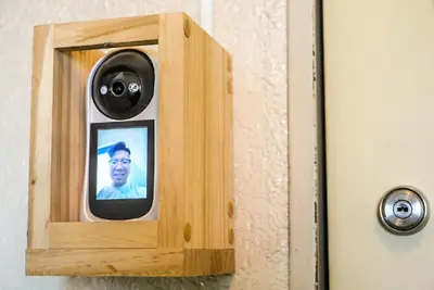 a picture of a man is inserted into a wooden door at SIC Hotel Shinjuku - Shin Nakano in Tokyo