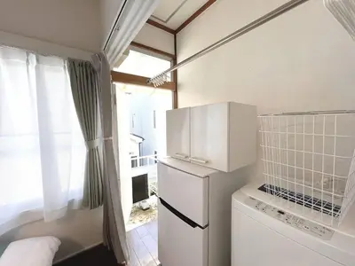a small kitchen with a refrigerator and a window at Chelsea Hatsudai 202 CH22 in Tokyo