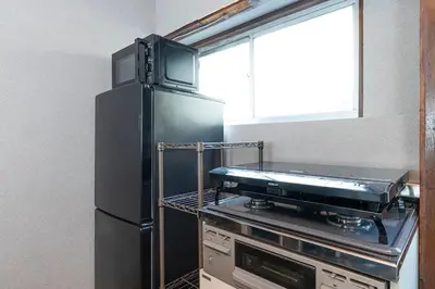 a kitchen with a black refrigerator and a stove at \u9418\u30f6\u6df5Stay in Tokyo