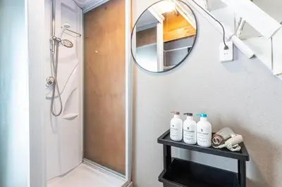 a bathroom with a shower and a mirror at \u9418\u30f6\u6df5Stay in Tokyo
