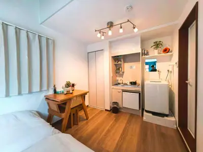 a bedroom with a bed and a desk and a kitchen at Mossy Nest Negishi I \u9daf\u8c37\u99c5\u5f92\u6b697\u5206 \u4e0a\u91ce\u5f92\u6b69\u570f\u5185 in Tokyo