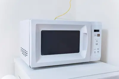 a white microwave oven sitting on top of a counter at Haleluana SHIBAMATA in Tokyo