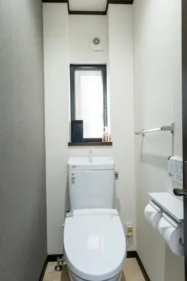 a bathroom with a toilet with a window in it at Haleluana SHIBAMATA in Tokyo