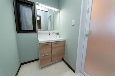 a bathroom with a sink and a mirror at Haleluana SHIBAMATA in Tokyo