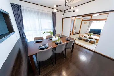 a dining room with a table and chairs at Haleluana SHIBAMATA in Tokyo