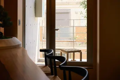 a room with a table and chairs and a window at Tsubomi Shibuya in Tokyo