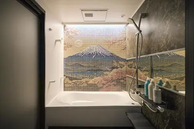 a bathroom with a bath tub with a large window at Tsubomi Shibuya in Tokyo
