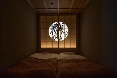 a bedroom with a window with a bed in front of it at Tsubomi Shibuya in Tokyo
