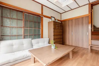 a living room with a white couch and a table at Ymn\u5c0f\u83c52\u4e01\u76ee in Tokyo