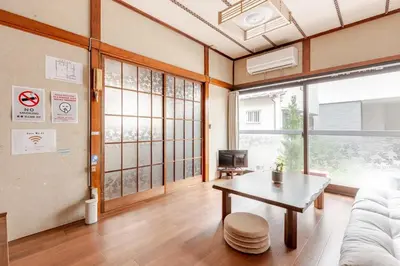 a living room with a table and a couch at Ymn\u5c0f\u83c52\u4e01\u76ee in Tokyo