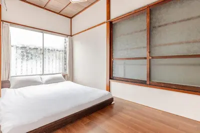 a bedroom with a bed and a window at Ymn\u5c0f\u83c52\u4e01\u76ee in Tokyo