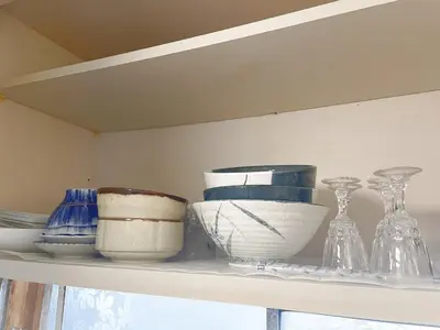 a shelf with bowls and vases on it at Ymn\u5c0f\u83c52\u4e01\u76ee in Tokyo