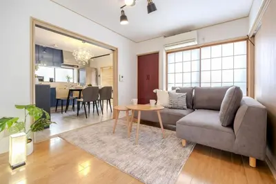 a living room with a couch and a table at Kasai Cozy House in Tokyo