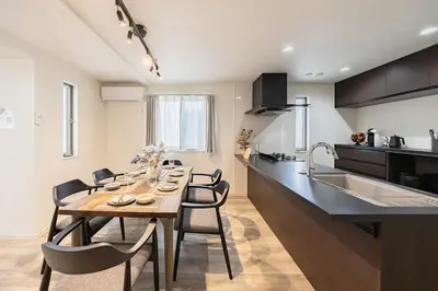 a kitchen and dining room with a table and chairs at Akari HOTEL in Tokyo