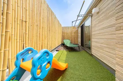 a childrens play area with a wooden wall and a chair at Akari HOTEL in Tokyo
