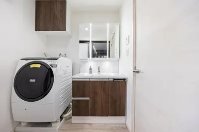 a small kitchen with a microwave and a sink at Akari HOTEL in Tokyo