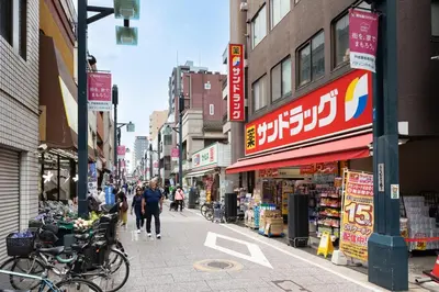 a city street with people walking down the street at Akari HOTEL in Tokyo