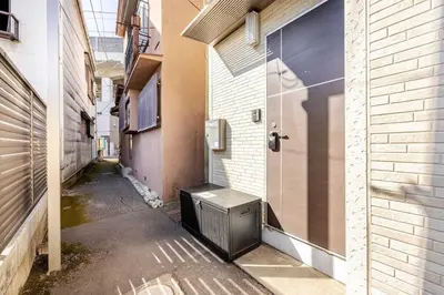 an alley with a door in the side of a building at sMS\u8db3\u7acb2\u4e01\u76ee in Tokyo
