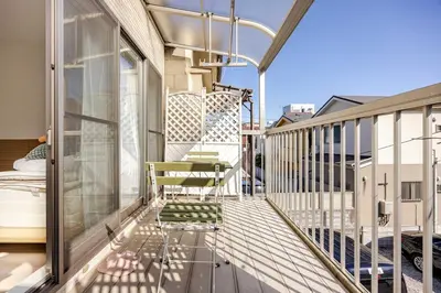 a balcony with a chair and a bed on it at sMS\u8db3\u7acb2\u4e01\u76ee in Tokyo