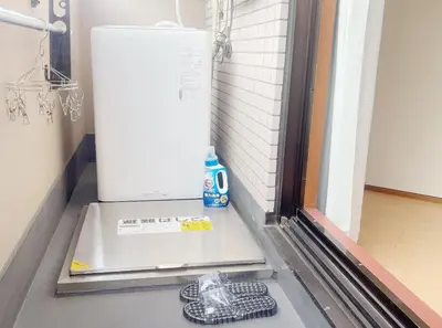 a white refrigerator sitting on a floor next to a door at 2F 3 minutes walk from Nishi-Oi Station, Shinagawa Ward, 4 stations available, surrounded by commercial streets, rich life, convenient transportation in Tokyo