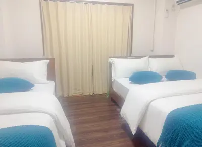 a room with two beds with blue pillows on them at 3F 3 minutes walk from Nishi-Oi Station, Shinagawa Ward, 4 stations available, surrounded by commercial streets, rich life, convenient transportation in Tokyo