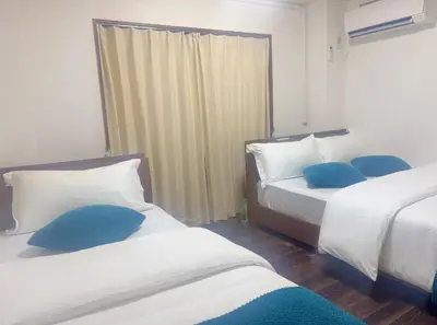 a bedroom with two beds with blue pillows at 3F 3 minutes walk from Nishi-Oi Station, Shinagawa Ward, 4 stations available, surrounded by commercial streets, rich life, convenient transportation in Tokyo